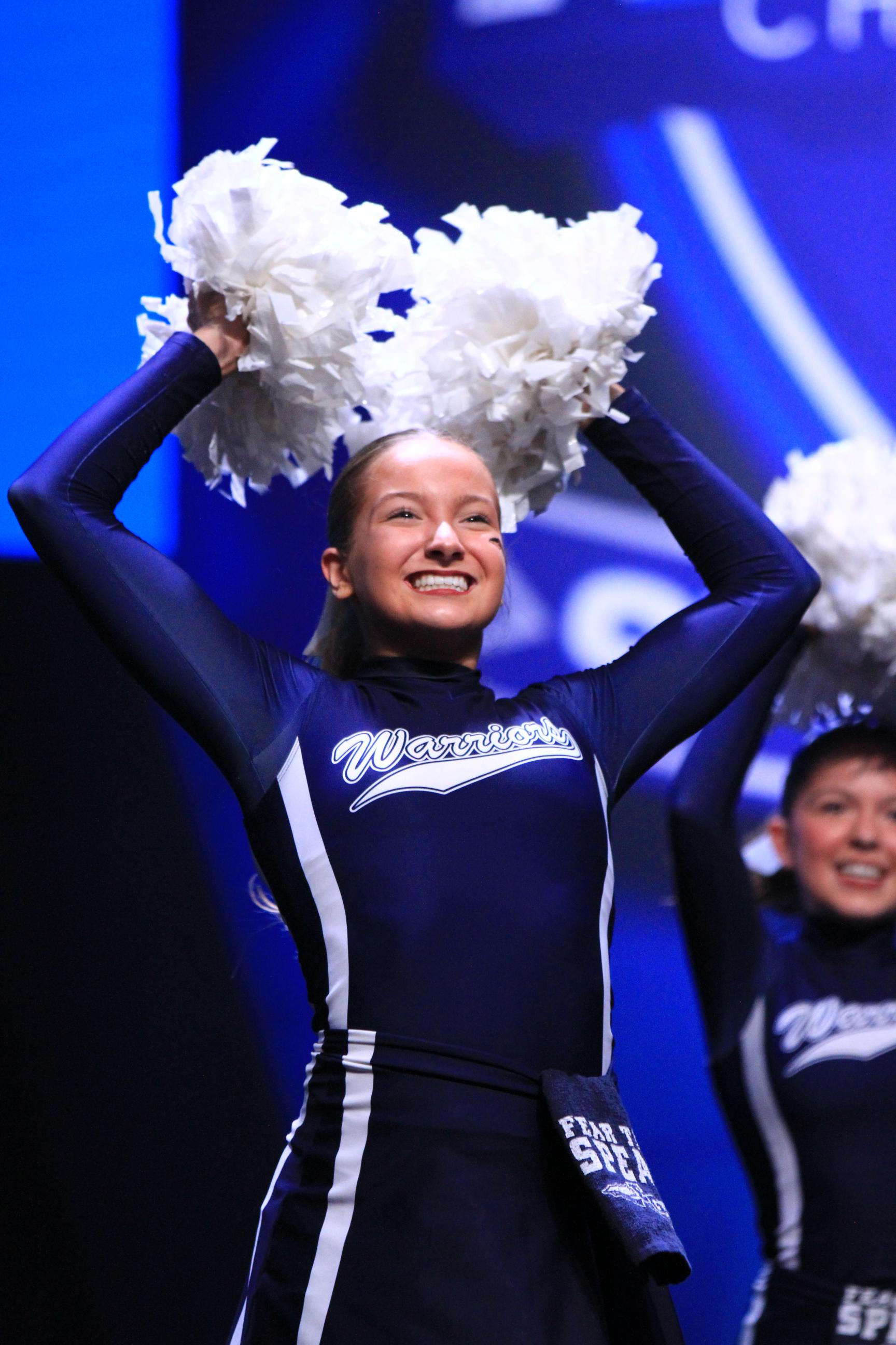 Cheerleader girl in performing on stage