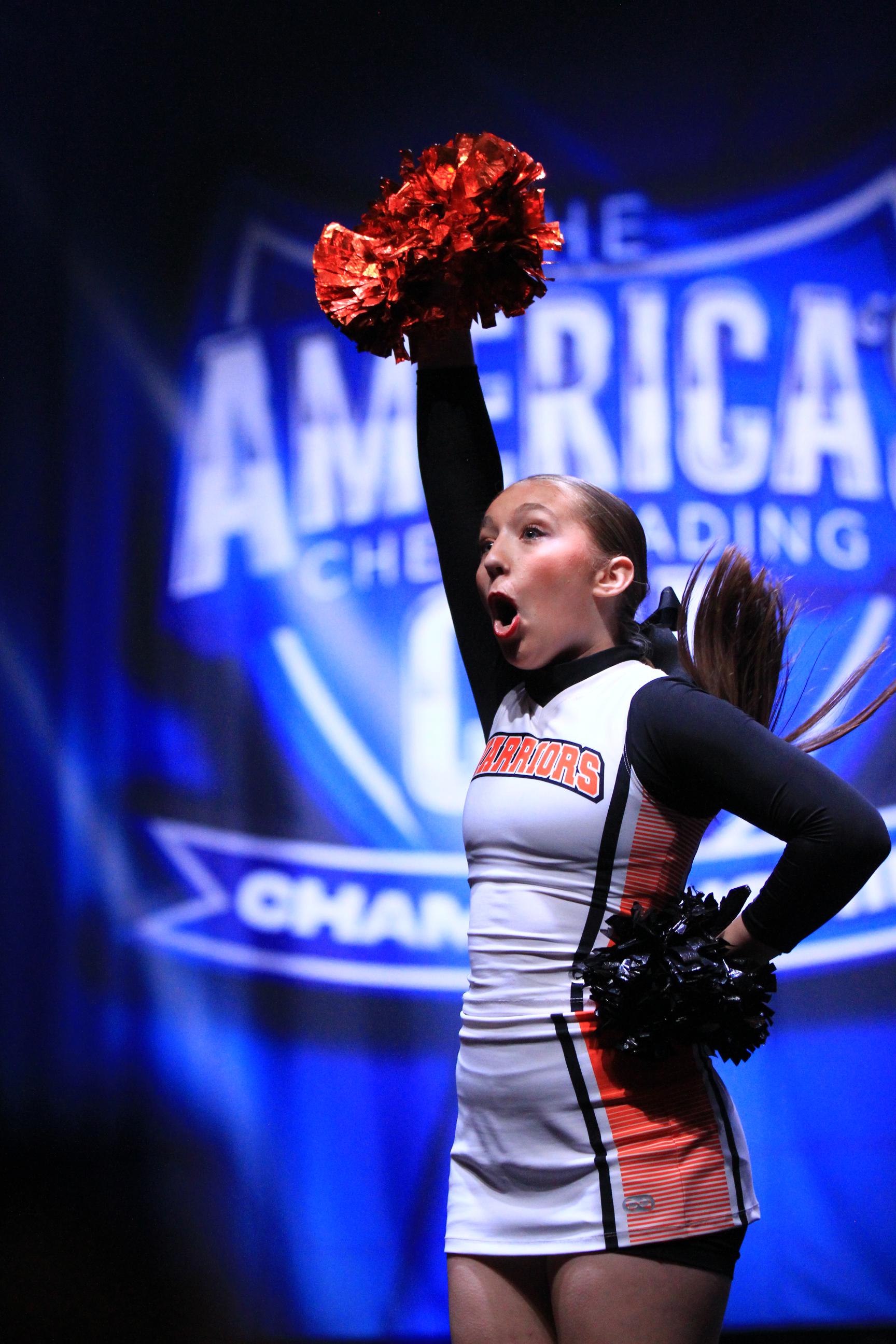 Cheerleader girl is performing on The America's Cheerleading Cup