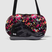 Nfinity Beast mid-top cheer shoe in black with a paint-splatter shoe case